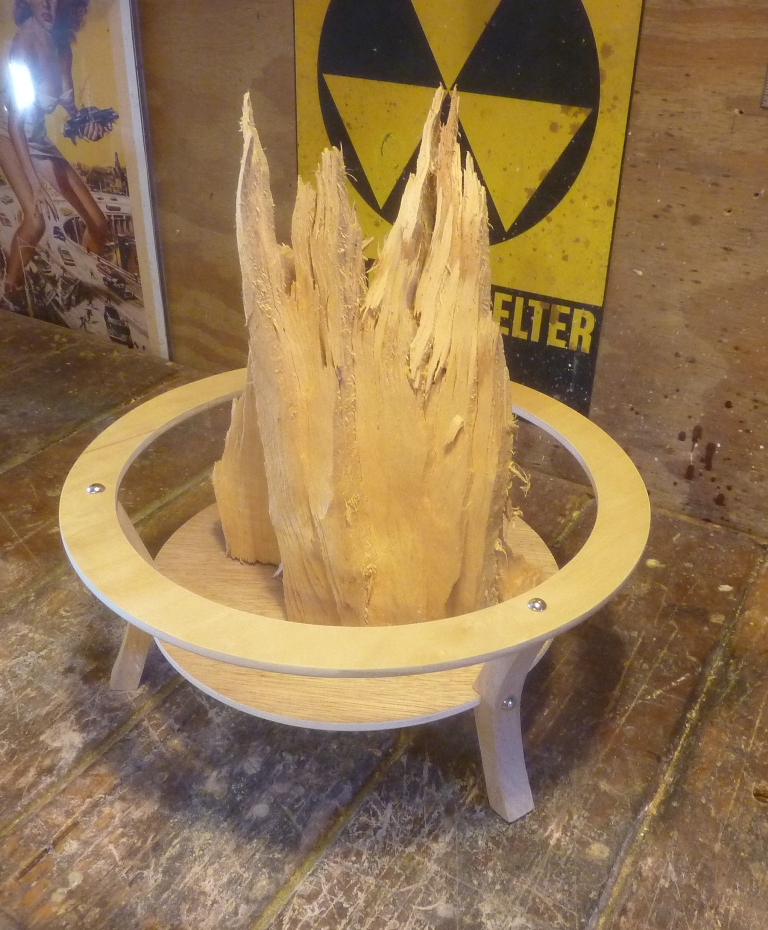 The faux fire pit enclosing the cypress fragment.